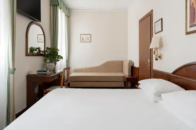 Letto o letti in una camera di Hotel Boccaccio