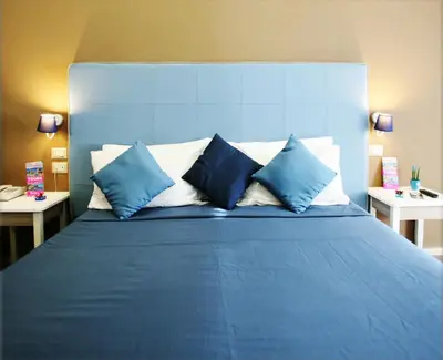 Letto o letti in una camera di Hotel Magenta