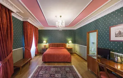 Letto o letti in una camera di Strozzi Palace Hotel