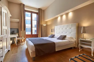 Letto o letti in una camera di Hotel Cosimo de' Medici