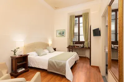 Letto o letti in una camera di Hotel Cimabue