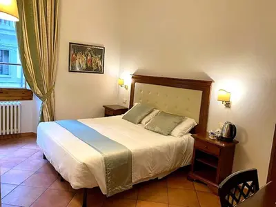 Letto o letti in una camera di Hotel Cimabue