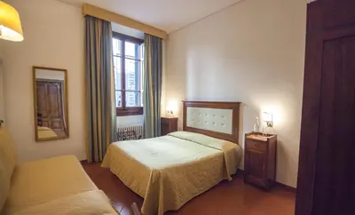 Letto o letti in una camera di Hotel Cimabue