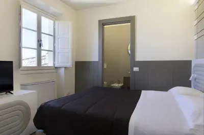 Letto o letti in una camera di Palazzo dei Ciompi Suites