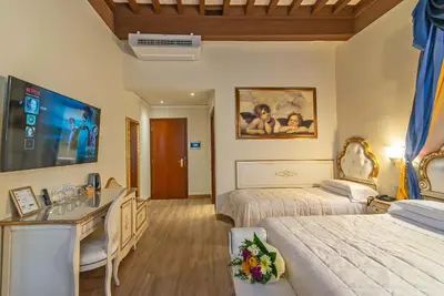 Letto o letti in una camera di Hotel Porta Faenza