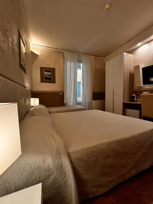 Letto o letti in una camera di Hotel Alinari