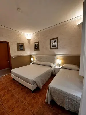 Letto o letti in una camera di Hotel Alinari