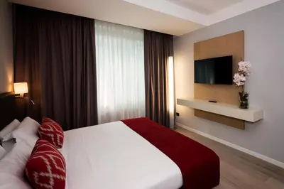Letto o letti in una camera di JR Hotels Gigli Firenze