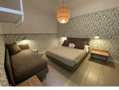 Letto o letti in una camera di Hotel Nella