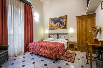 Letto o letti in una camera di Hotel Collodi Firenze