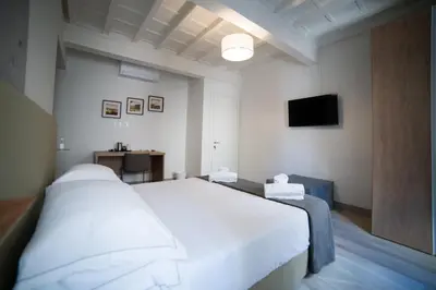 Letto o letti in una camera di Coco Places Rooms Santa Maria Novella, Centro Storico