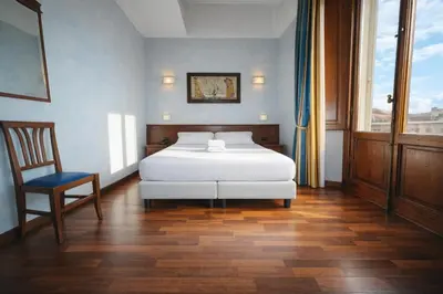 Letto o letti in una camera di Hotel Palazzo Vecchio
