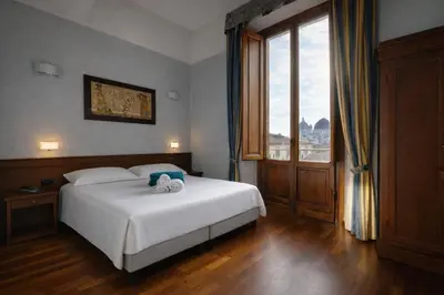 Letto o letti in una camera di Hotel Palazzo Vecchio
