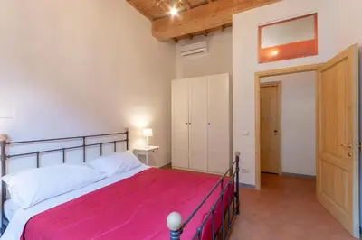 Letto o letti in una camera di Sant'Agostino Apartments