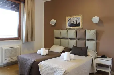 Letto o letti in una camera di Hotel Franchi