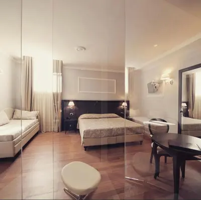 Letto o letti in una camera di Hotel Lombardia