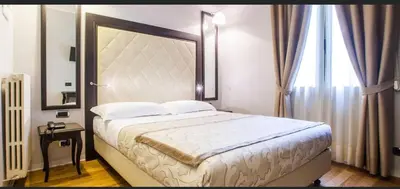 Letto o letti in una camera di Hotel Lombardia