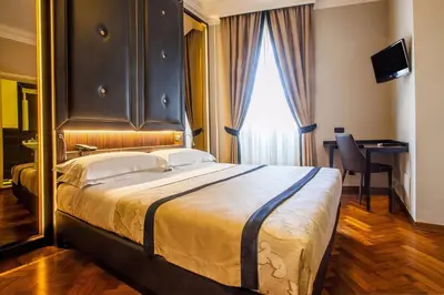 Letto o letti in una camera di Hotel Lombardia