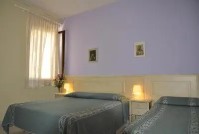 Letto o letti in una camera di Hotel Regina