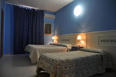 Letto o letti in una camera di Hotel Regina