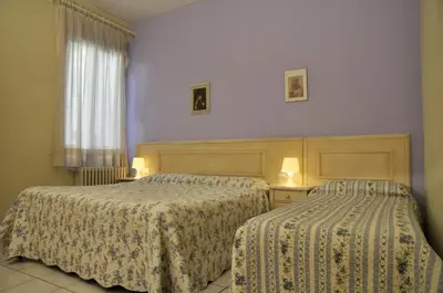 Letto o letti in una camera di Hotel Regina