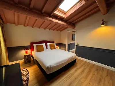 Letto o letti in una camera di JOIVY Together Florence Secret Nest