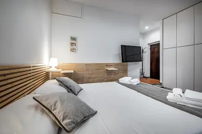 Letto o letti in una camera di Roommo Via dei Pilastri giada