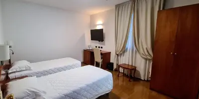 Letto o letti in una camera di Hotel La Villetta
