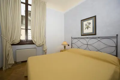 Letto o letti in una camera di Palazzo Gamba Apartments al Duomo