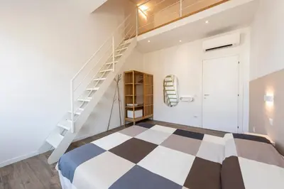 Letto o letti in una camera di Ruote Stylish Loft by Mmega