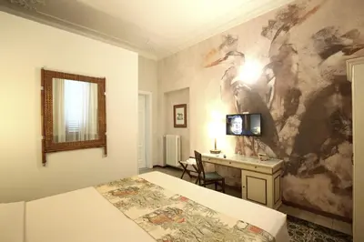 Letto o letti in una camera di MADAMA GUEST HOUSE