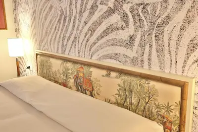Letto o letti in una camera di MADAMA GUEST HOUSE