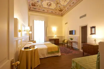 Letto o letti in una camera di Hotel Firenze Capitale