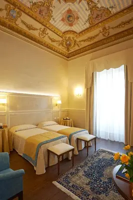 Letto o letti in una camera di Hotel Firenze Capitale