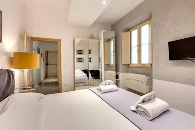 Letto o letti in una camera di Conce Apartment by Mamo Florence