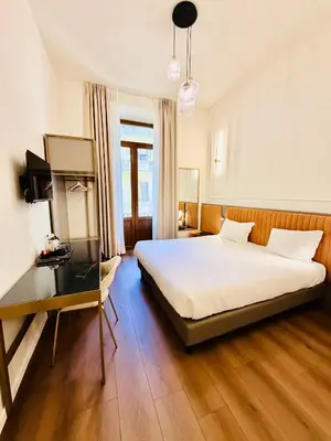 Letto o letti in una camera di Hotel Duca D'Aosta