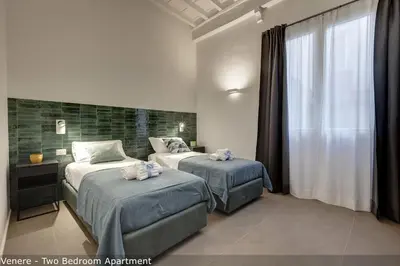 Letto o letti in una camera di Venere & Zefiro Apartments by Mamo Florence
