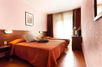 Letto o letti in una camera di Hotel Corolle