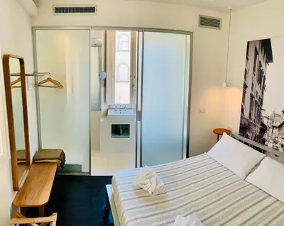 Letto o letti in una camera di UFFIZI & SANTO SPIRITO Family/Groups Apartment