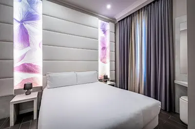Letto o letti in una camera di B&B Residenza le Fonticine