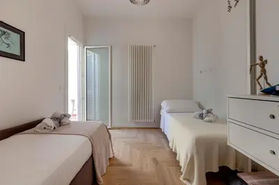 Letto o letti in una camera di Guya Apartment by Mamo Florence