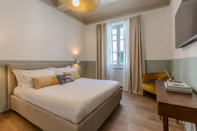 Letto o letti in una camera di B&B Stanze Guelfe