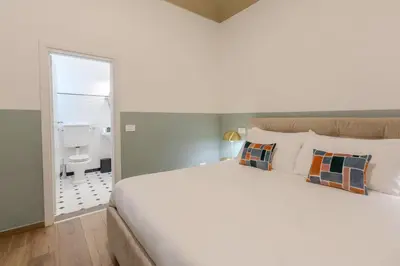 Letto o letti in una camera di B&B Stanze Guelfe