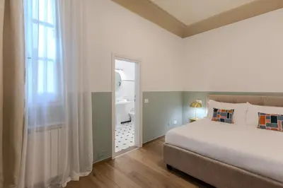 Letto o letti in una camera di B&B Stanze Guelfe