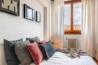 Letto o letti in una camera di Apartments Florence- Accademia Charme